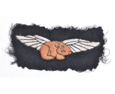 A scarce original WWII Second World War ' Guinea Pig Club ' cloth uniform patch. Black, with central brown and white winged G