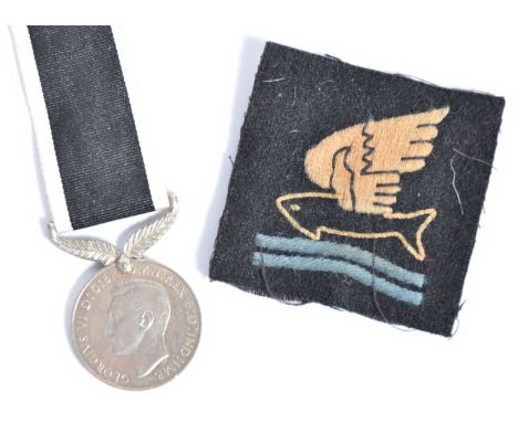 A WWII Second World War ' For Service To New Zealand ' medal (with ribbon), along with a ' Goldfish Club ' cloth patch. Both 