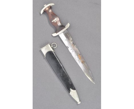 A WWII Second World War German Nazi Third Reich NSKK dagger having a shaped wooden grip with inset SA roundel and Eagle clutc