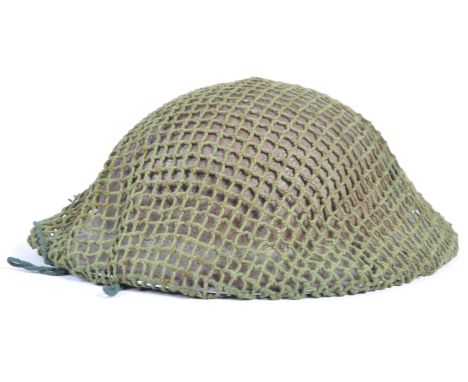 A WWII Second World War British Army all steel brodie combat uniform helmet being complete with the original liner and canvas