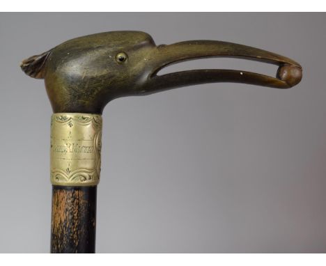 An Ebonised Walking Cane with Carved and Moulded Horn Handle in the Form of a Bird with Pea in Beak, White Metal Band Inscrib