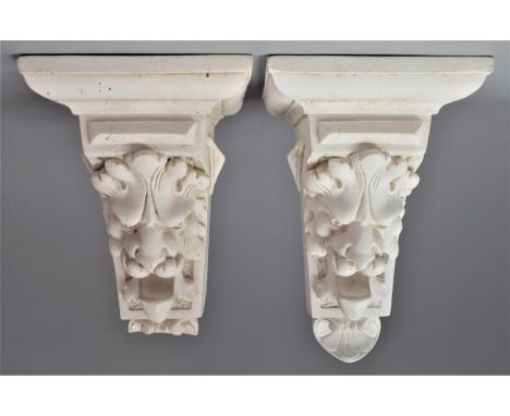 A Pair of Moulded Plaster Wall Hanging Lion Mask Shelf Sconces, 26cm high, One with Loss to Base 