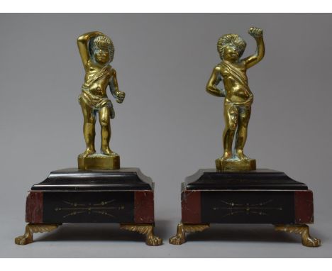 A Pair of French Bronze and Marble Clock Garnitures in the Form of Cherubs Which Would Formerly Have Held Spears or Similar, 