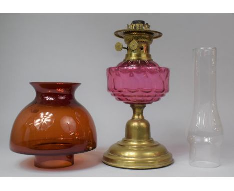 A 20th Century Brass Oil Lamp with Cranberry Glass Reservoir and Unrelated Shade and Chimney, Lamp 32cm high 