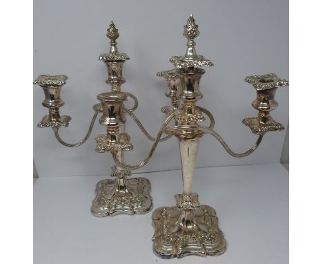 A pair of silver plated candelabra. Repoussé work, elegant swirled design, flame removable finial centre. Filled bases. 