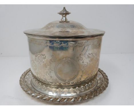An engraved silver plated biscuit barrel on pierced stand, engraved with ribbon and stylized foliate decoration. Central roun