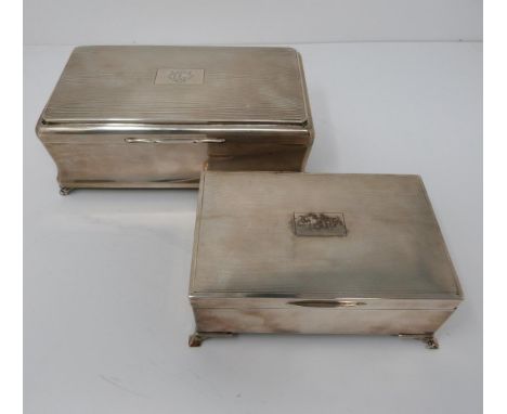 A pair of wooden lined silver cigarette boxes, the larger one with engine turned decoration and engraved monogramme BC, hallm