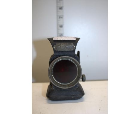 A vintage Joseph Lucas 'Warna' bicycle oil lamp with red glass 
