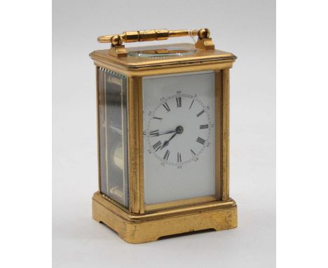 A French lacquered brass cased carriage clock having an enamel dial with inner Roman numerals and Arabic outer scale, with vi