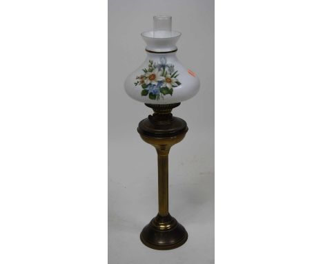 A late Victorian brass oil lamp with floral decorated milk glass shade, height 69cm