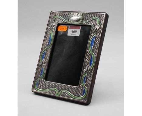 An Art Nouveau style silver clad easel photograph frame, of rectangular form, having sinuous blue and green enamel floral dec