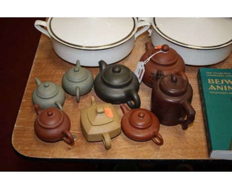 A Chinese export Yixing teapot, of squat circular form, incised with a male figure in seated pose, with further Chinese scrip