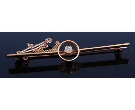 A yellow metal diamond bar brooch, featuring an Old European cut diamond in an open circular bezel setting, with roller catch