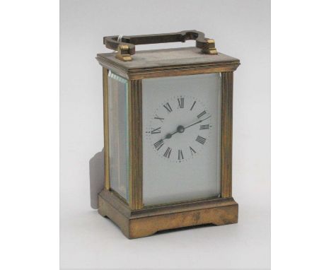 A 20th century lacquered brass cased carriage clock having an enamel dial with Roman numerals, visible platform lever escapem