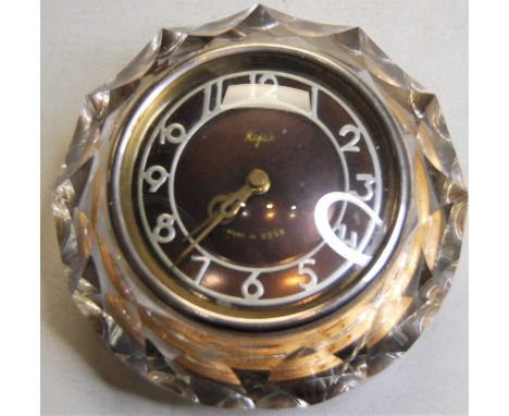 A mid-20th century Russian Majak wall clock, having a raised silvered dial with Arabic numerals within a glass surround 