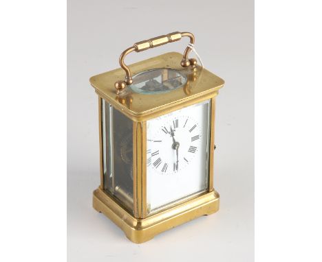 Antique French brass travel alarm clock with cut glass and enamel dial.&nbsp;Circa 1900. Dimensions: 12 x 8 x 6 cm.&nbsp;In g