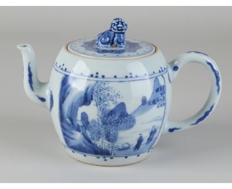 Chinese porcelain teapot with wings/landscape/figures/valuables decor.&nbsp;Foo dog on lid.&nbsp;With blue bottom ring.&nbsp;