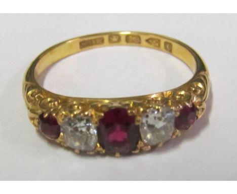 A ruby and diamond ring five stones on 18ct gold band, ring size O