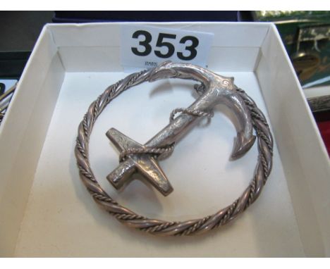 A silver brooch in the form of an anchor and bangle