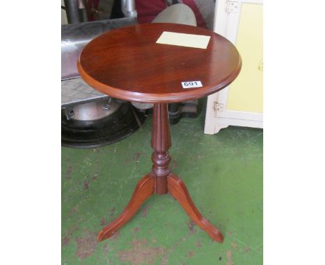 A mahogany circular top tripod table