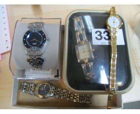 A ladies Swatch watch blue face and pierced decorative strap and three other ladies watches