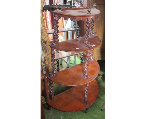 A Victorian mahogany four tier demi-lune shelf with wrythen twist supports