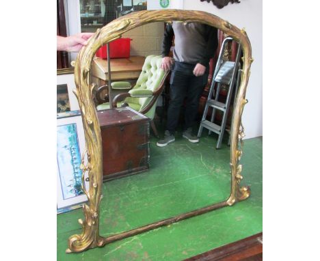 A large 19th Century gilt overmantel mirror with tree trunk and flower design frame