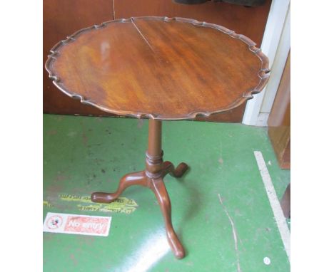 A mahogany pie crust edge table on pillar and tripod base