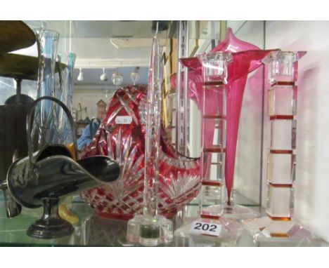 A red glass basket, trumpet vase, pair candlesticks, vase, candle and plated sucrier