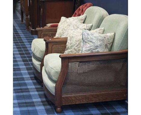 FOUR ERCOL OAK FRAMED BERGERE ARMCHAIRSwith green cushions