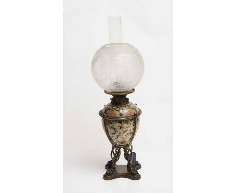 19TH CENTURY OIL LAMP
in the manner of Zsolnay Pecs, the ceramic reservoir and body with stylised floral designs and on a bra