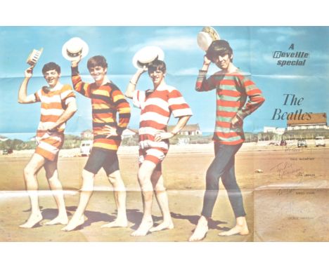 A rare original vintage 1960's ' The Beatles ' large poster. Depicting The Fab Four in full colour at the beach wearing beach