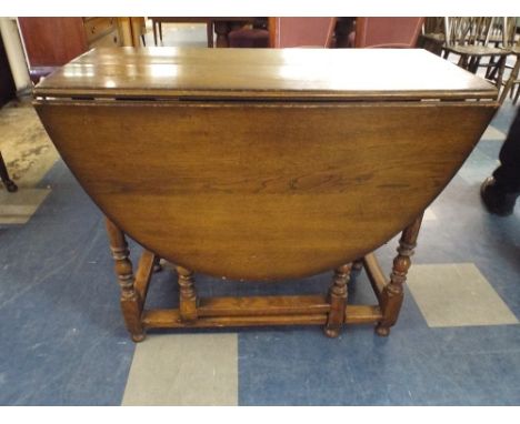 An Oak Gate Leg Drop Leaf Dining Table.