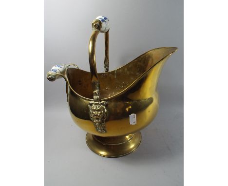 A Ceramic Handled Brass Helmet Shaped Coal Scuttle.