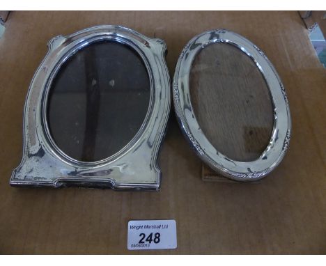 Two hallmarked silver easel back photograph frames of varying designs.