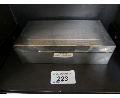 A Birmingham hallmarked silver cigarette case of hinged rectangular form with engine turned decoration and wood lined interio