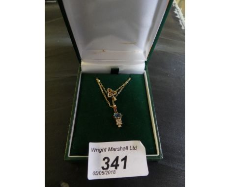 A 9k gold, ruby and diamond trefoil pendant and chain, together with, a 9k gold, blue topaz and cubic zirconia pendant neckla