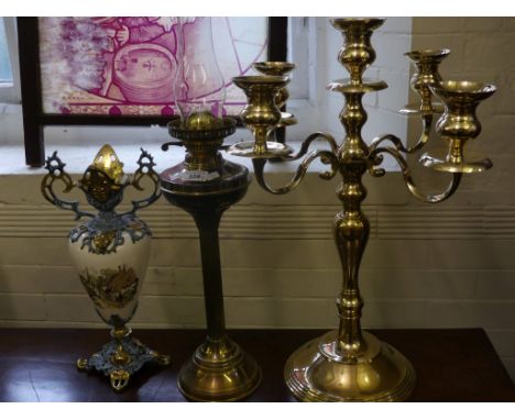 A mixed lot comprising a large modern brass five light candelabra together with a brass oil lamp and a metal mounted ceramic 