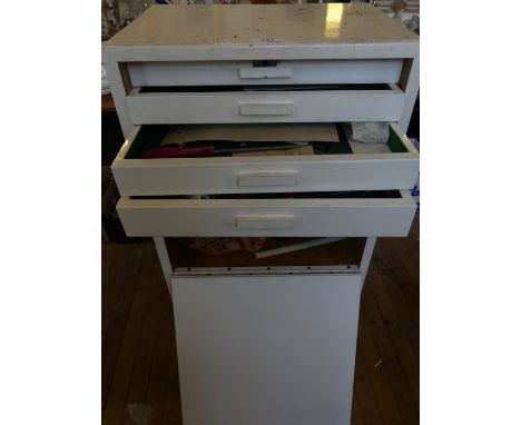 A small white painted multi drawer cabinet containing many files and small tools for jewellery making.