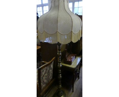 A brass electric standard lamp with cream fabric shade (sold electrically untested)