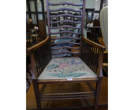 An Edwardian mahogany ladderback armchair with floral tapestry seat 