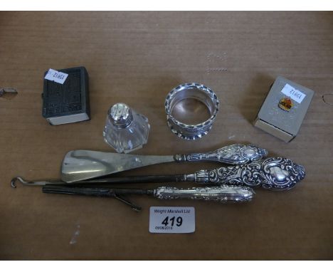 A mixed lot comprising silver handled button hooks, shoe horn, silver napkin ring and two further matchbox covers 