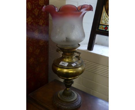 A Victorian oil lamp with frilled glass shade with later electrical conversion (sold electrically untested)