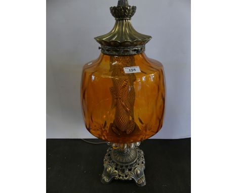A brass based electric table lamp with large amber glass shade (sold electrically untested).