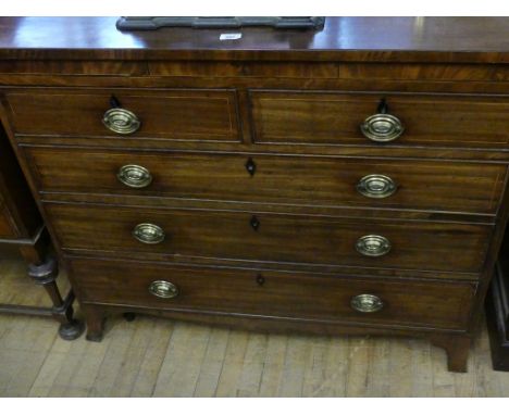 A late Georgian mahogany chest of drawers, having two short and three long drawers, with oval brass plate handles, raised on 