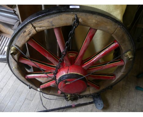 A centre ceiling light fitting, formed from a cartwheel