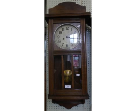 A 20th Century oak cased wall clock, with glazed front door