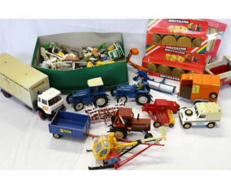 Collection of Britain's farm models unboxed including Fiat 880DT tractor, 2 Ford 7710 tractors, tipping trailer, harrow, New 