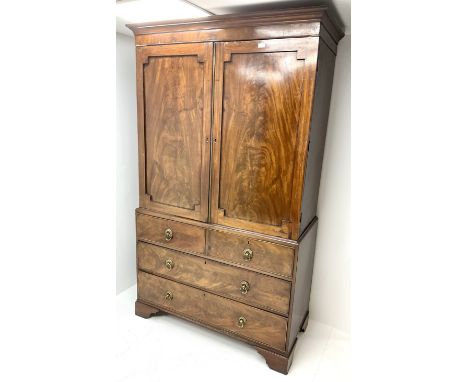 Early 19th century mahogany linenpress, projecting cornice above two doors enclosing four slides, two short and two long draw
