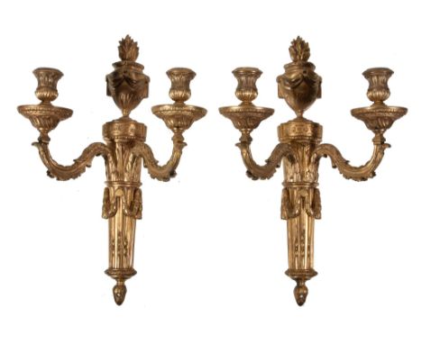  A pair of gilt bronze twin light wall appliques in Louis XVI style,   early 20th century, each with urn sockets on spiral fl